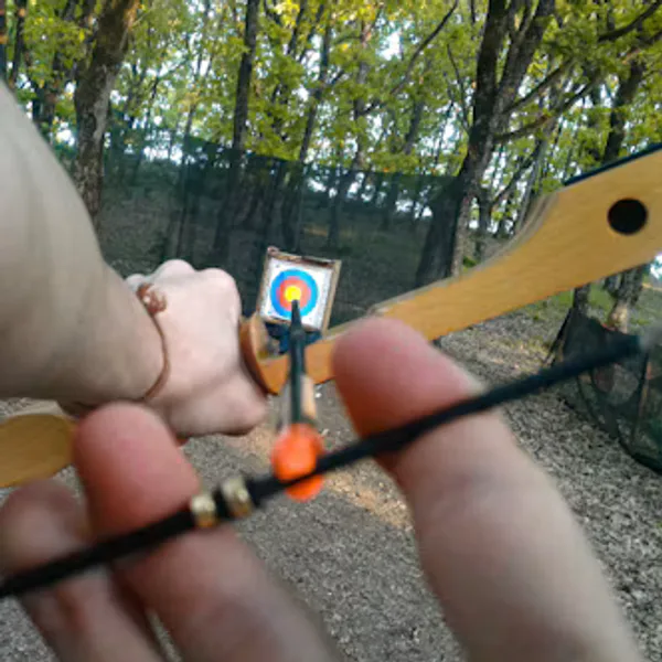 An archer’s view down a recurve at a backyard target